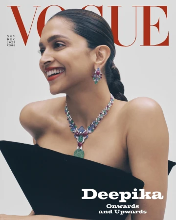 Deepika Padukone wearing an elaborate jewelled necklace and earrings against a plain background