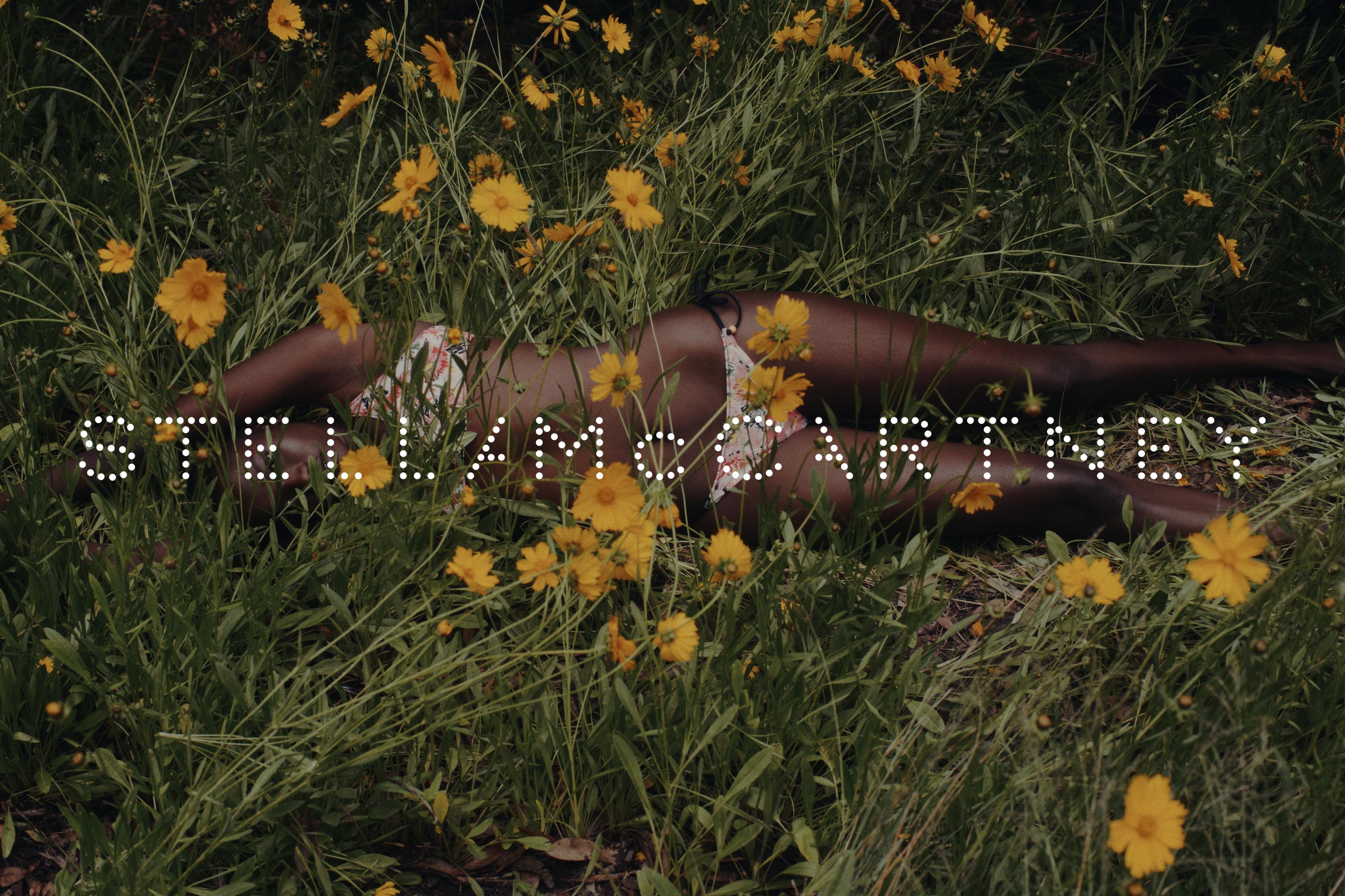 Woman in floral bikini lies in field of Coreopsis flowers, shadowed light, 'Stella McCartney' text overlay, fashion, beauty, nature theme.