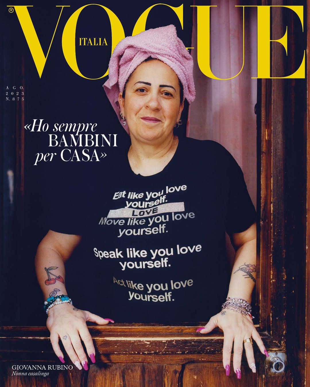 Vogue Italia cover featuring Giovanna Rubino in a black t-shirt with white text, a pink towel on her head, and tattoos on her arms.