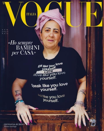 Vogue Italia cover featuring Giovanna Rubino in a black t-shirt with white text, a pink towel on her head, and tattoos on her arms.