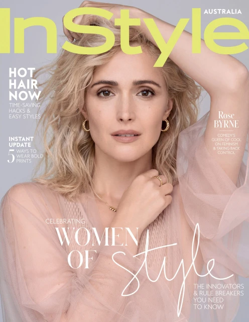 Rose Byrne on the cover of InStyle Australia magazine. She poses with her hand near her face and wavy blonde hair.