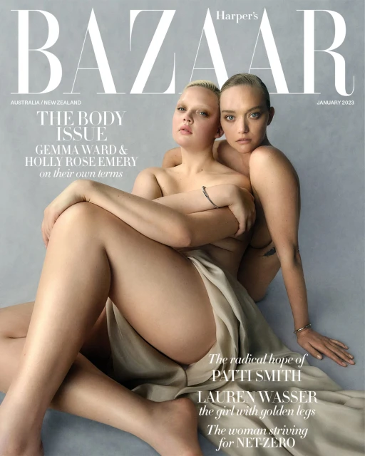Harper's Bazaar magazine cover featuring models Gemma Ward and Holly Rose Emery, January 2023 issue, posing nude with draped fabric.