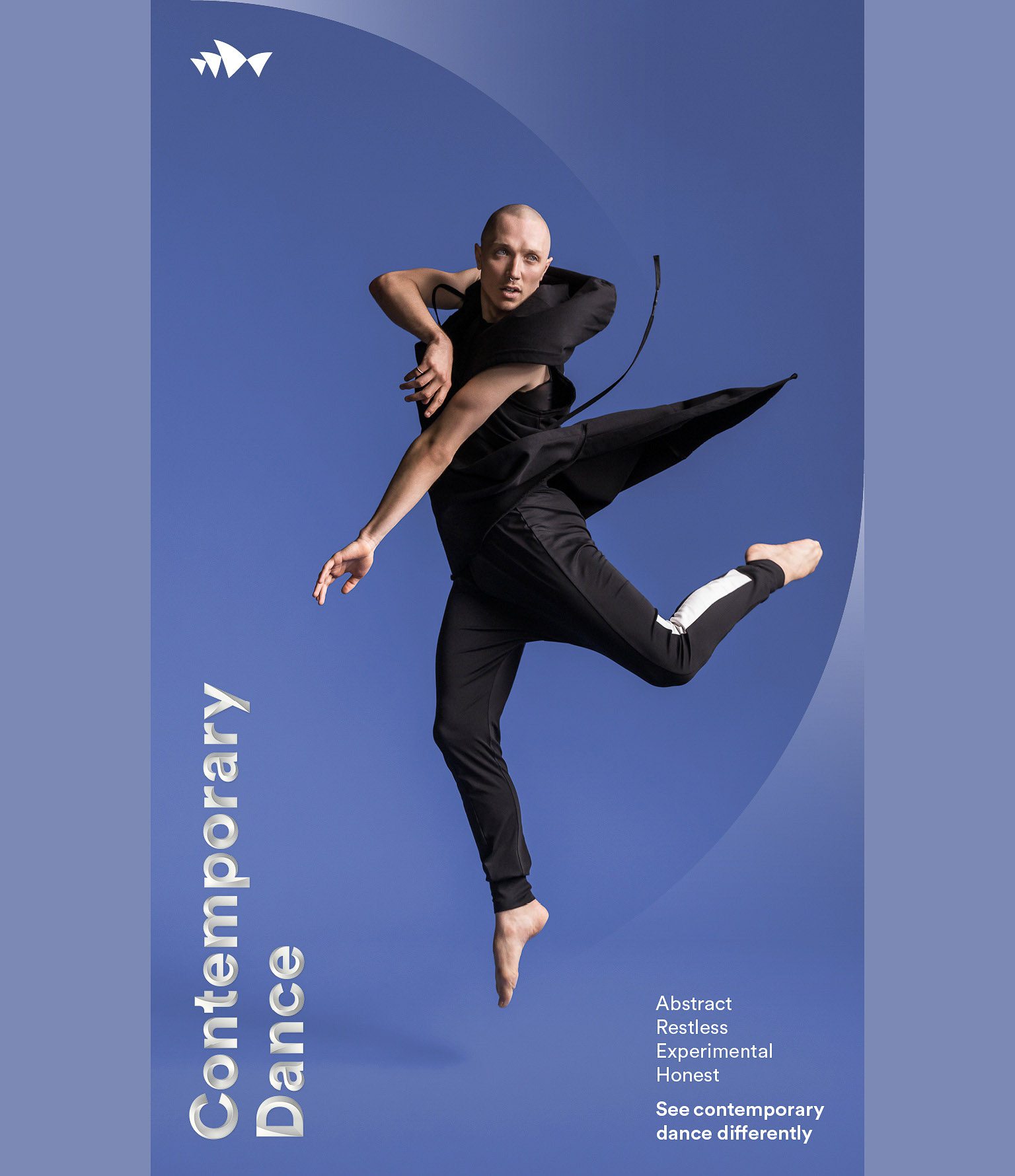 Male dancer leaping in a dance studio with a blue backdrop. He is wearing a black costume with white stripe down side of pants.