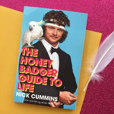 Book cover featuring a man in a tuxedo with a cockatoo on his shoulder, set against a pink glitter background and gold paper.