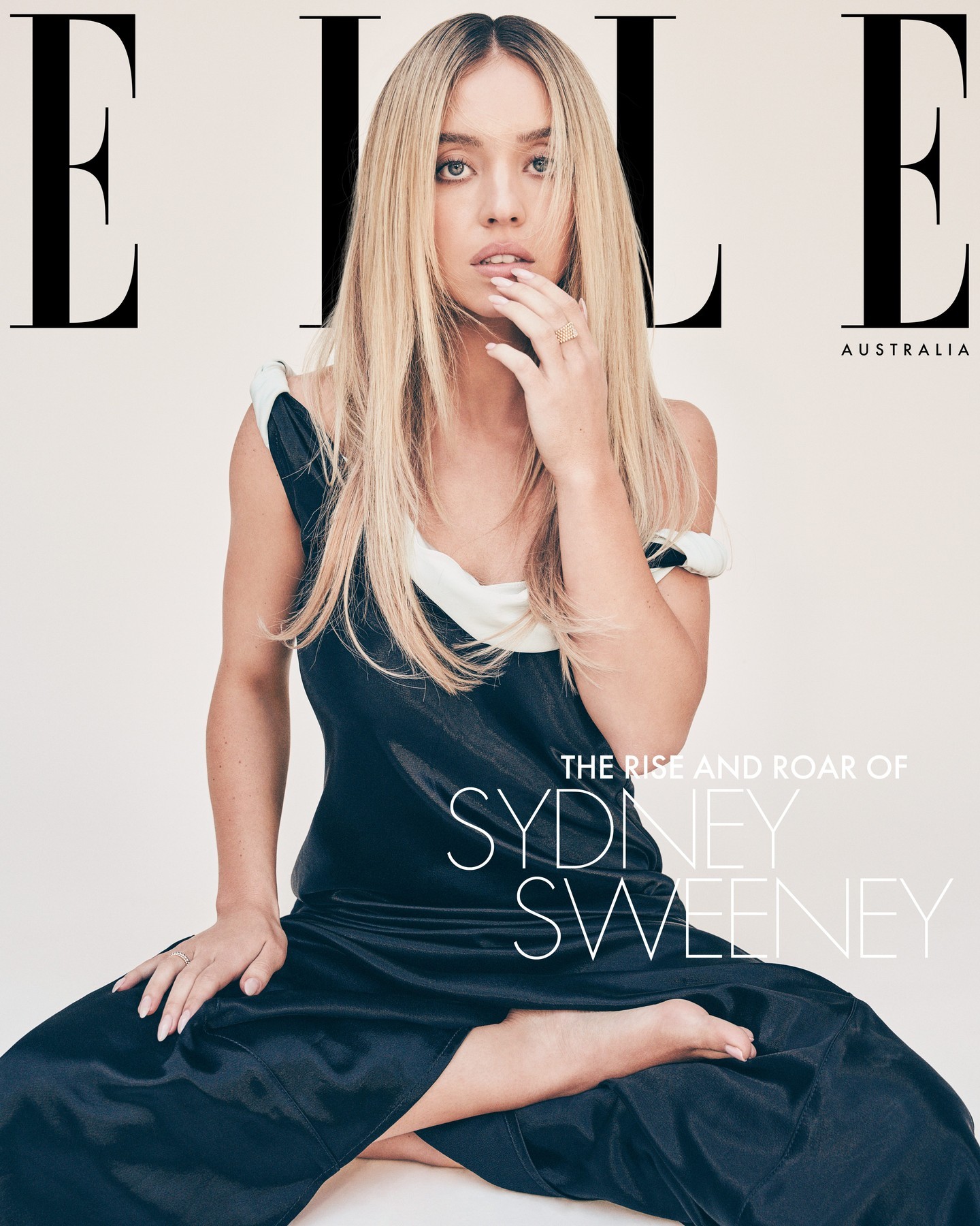 Elle Australia cover featuring Sydney Sweeney in a black and white dress, blonde hair, seated pose against a neutral background.