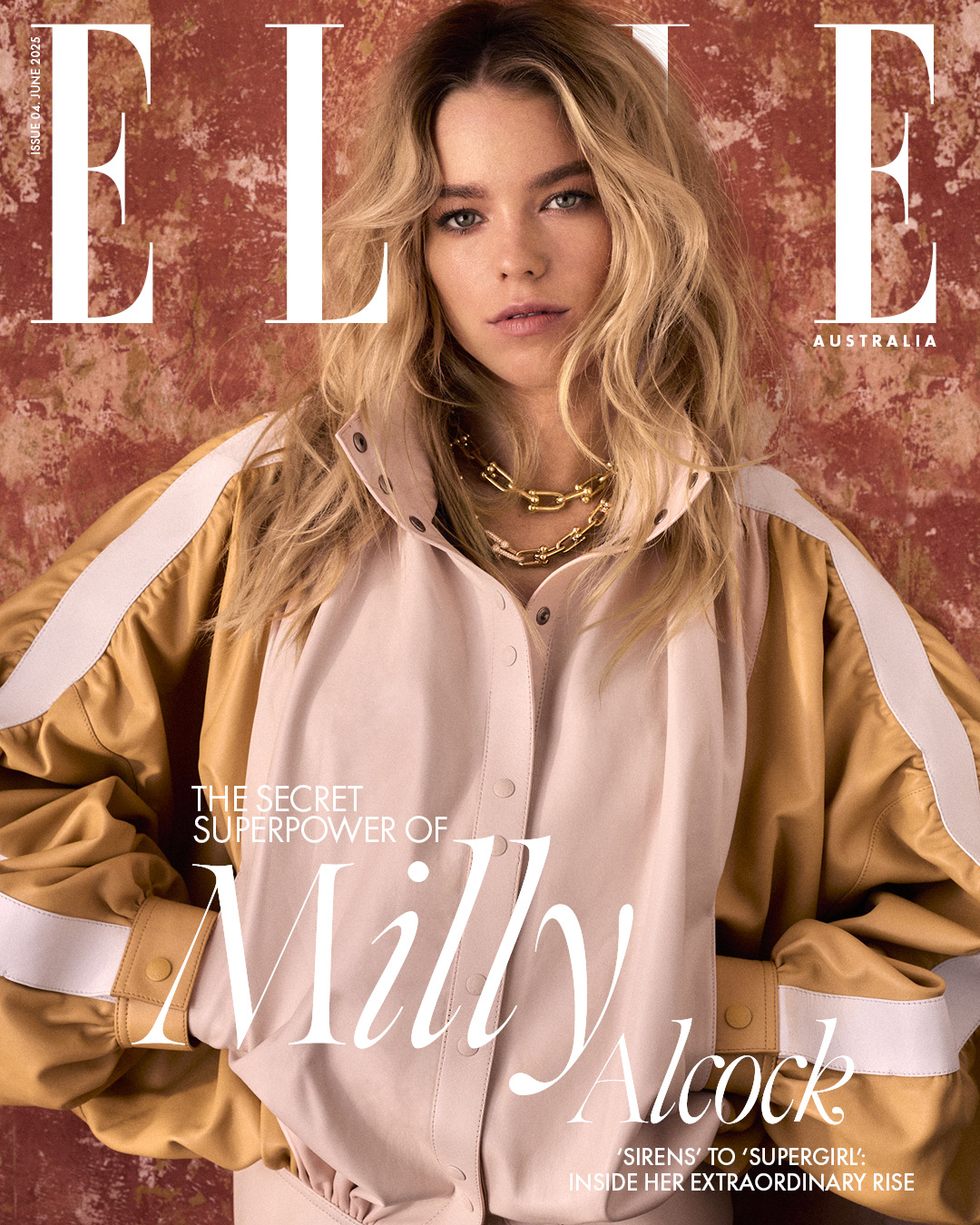 Milly Alcock on Elle Australia magazine cover. Close-up of a blonde woman in a bomber jacket against a textured background.