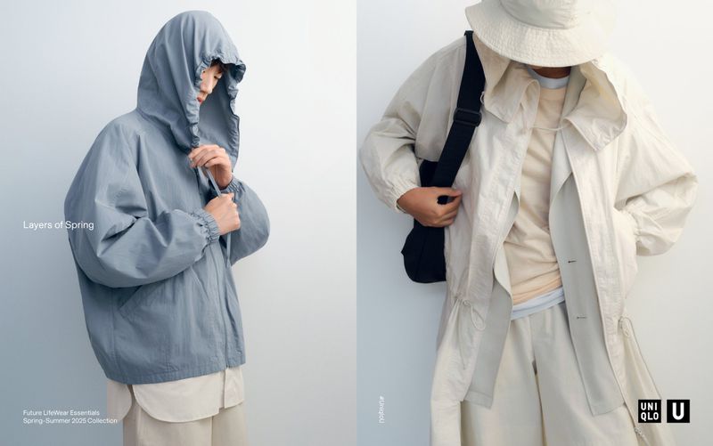 Two individuals showcase spring outerwear: one in a light blue hooded jacket, the other in a light beige jacket with a cross-body bag.
