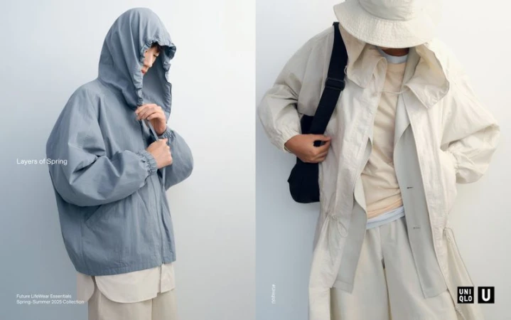 Two individuals showcase spring outerwear: one in a light blue hooded jacket, the other in a light beige jacket with a cross-body bag.