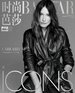 Carla Bruni posing in a belted black leather trench coat on a monochrome magazine cover.