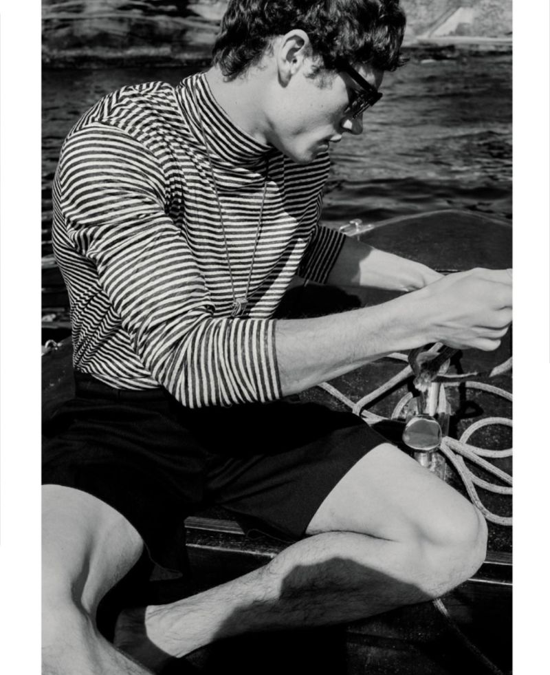 Valentin Humbroich wearing a striped turtleneck on a boat for A Salty Dog in ICON Magazine Italy