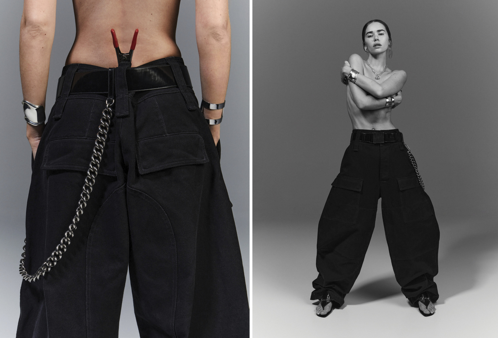 A fashion shot featuring a woman in oversized black trousers and silver jewelry against a grey backdrop, showcasing the garment's design.