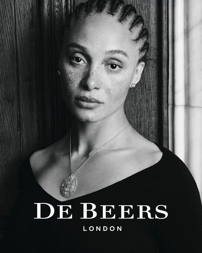 Portrait of model Adwoa Aboah wearing a diamond pendant necklace for De Beers shot in black and white