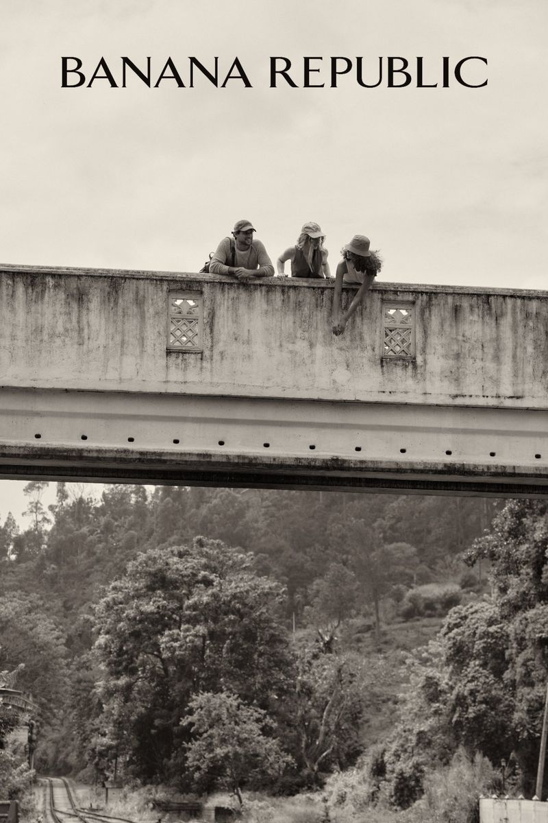 Sepia-toned image featuring three figures on a bridge overlooking a forest landscape, with the 'Banana Republic' logo at the top.