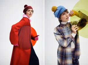 Model wearing a red coat and pom pom beanie holding an orange transparent disc against a white background for Helen Kaminski