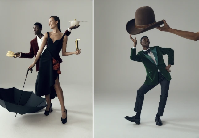 Two models strike fashion poses in a studio setting, one with a cooking pot and an umbrella, the other balancing a hat.