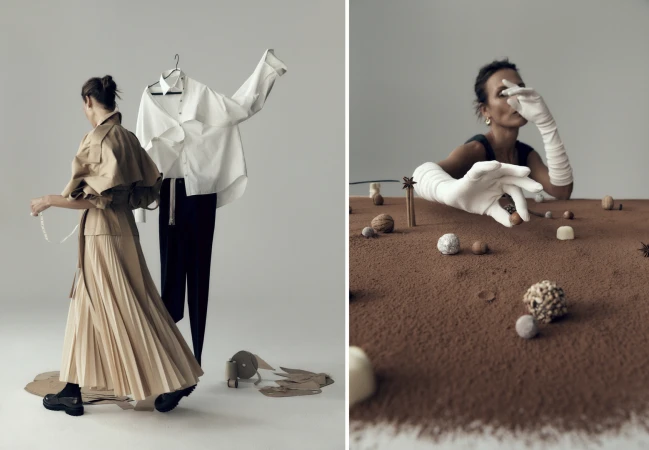 Fashion editorial shot with a woman in a flowing beige skirt, next to a hanging white shirt and black pants, and a tabletop dessert scene.