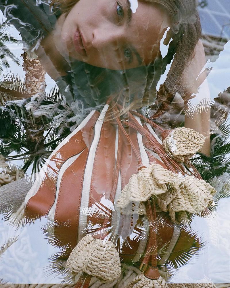 Portrait of a blond woman with a bucket bag and palm fronds with a multiple exposure effect creating a dreamlike aesthetic.