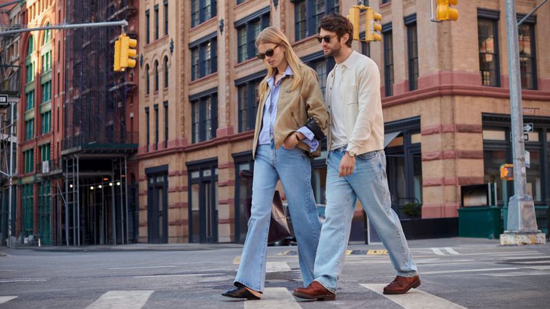 Daphne Groeneveld and Matthew Bell walking across a city street for Mavi Spring 2025 campaign photographed by Thomas Slack