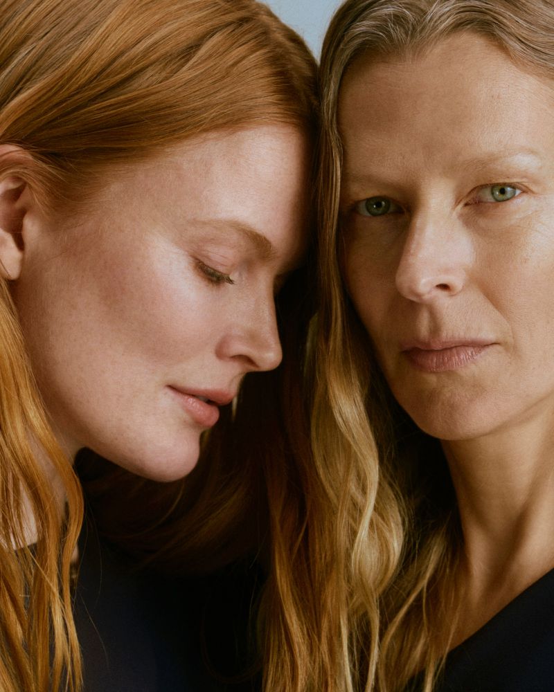Close-up portrait of two female models with long red hair posing together for Comma International Women's Day campaign