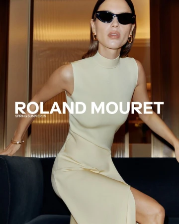 A woman poses on a sofa in a light-yellow dress and black sunglasses with Roland Mouret text overlayed, in a fashion editorial style.