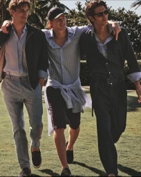 Three young men with arms around each other walking outdoors on a sunny day for the Paul & Shark S/S 2025 campaign.