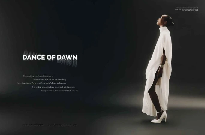 Elegant studio shot of an African-descent woman in a white kaftan and heels, accessorized with a wristwatch against a dark backdrop.