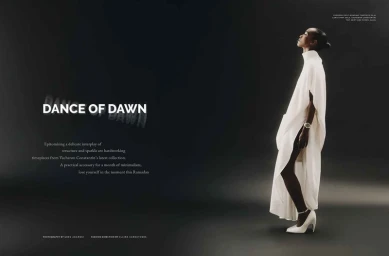 Model in flowing white dress and heels standing against a dark gradient studio background with typography