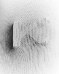 Textured white fabric stretched tightly over a three dimensional letterform creating soft directional shadows and highlights