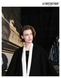 Model Berit Heitmann in a black and white coat outdoors under a bridge for La Biosthetique campaign by photographer Philip Gay