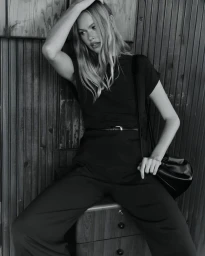 Model Emma Stern Nielsen posing against wood paneling in SEMICOUTURE SS25