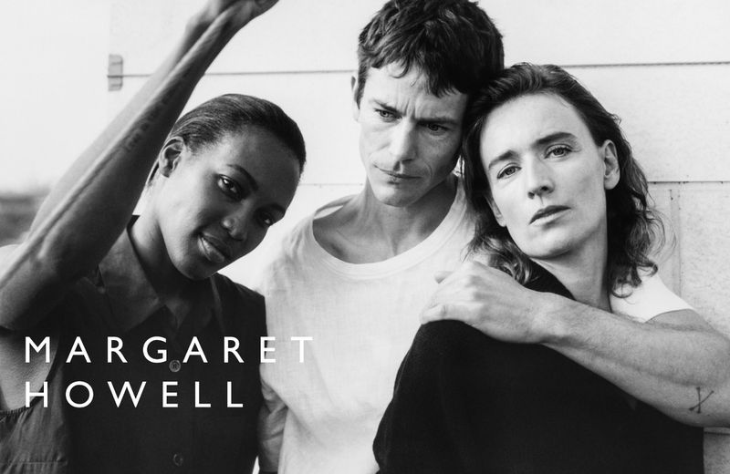 Black-and-white shot of three adults in casual clothing with Margaret Howell text overlay, showcasing minimalist, natural aesthetic.