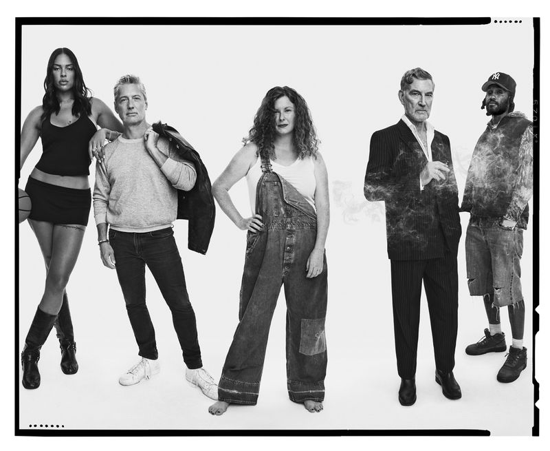 Black and white group portrait featuring five diverse adults in a photo studio setting with a basketball, overalls, and a suit.