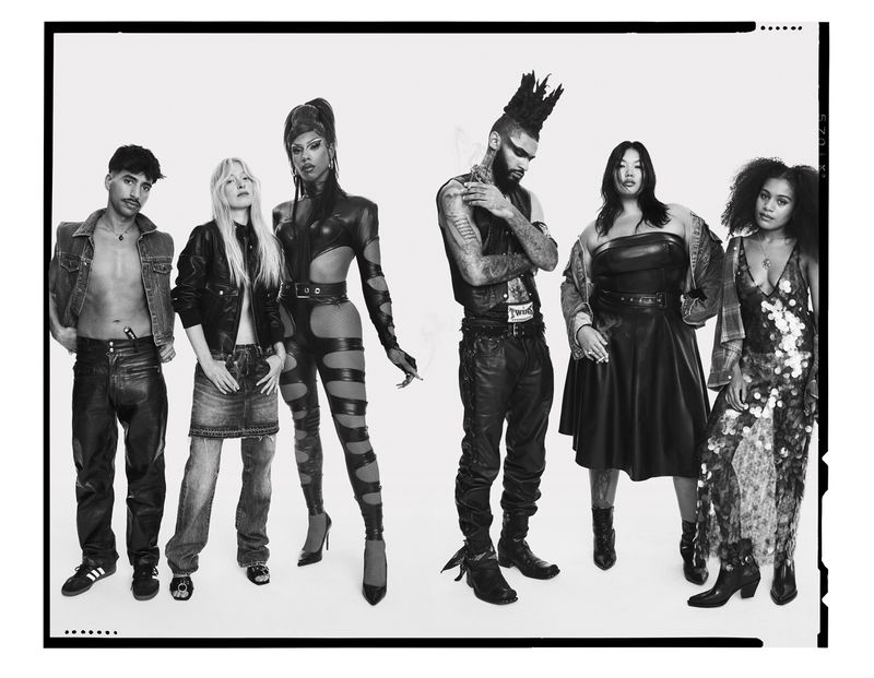 Black and white studio shot of six diverse adult models wearing fashionable clothing, standing in a white setting with a dark border.