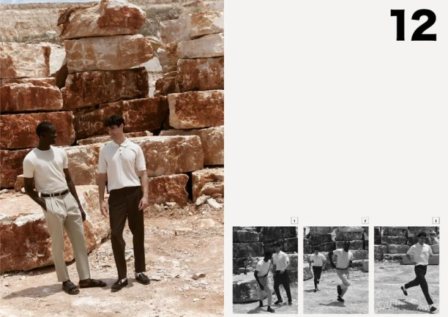 Two men pose in neutral-toned casual wear against a background of stacked rock formations under natural light, with a modern fashion editorial aesthetic.