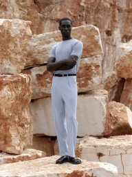 Black male model in light blue t-shirt and trousers posing against large rocky quarry wall