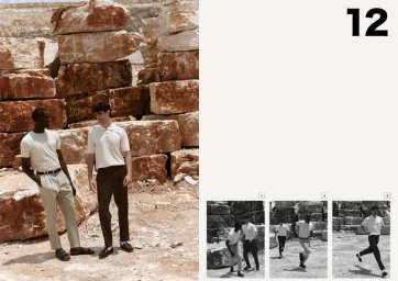 Two male models posing near a stacked stone quarry wall in white polo shirts and trousers for Avenue Flanee editorial by Giuseppe Vitariello