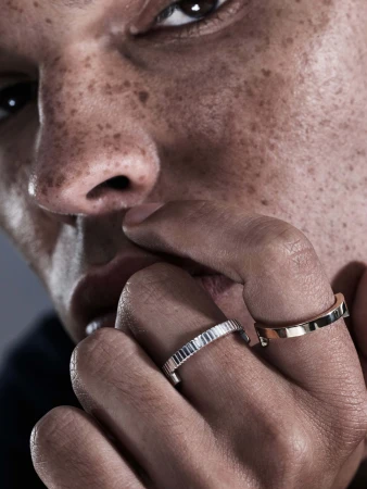 Close-up portrait of a man wearing two rings on his fingers near his face for Sarah & Sebastian