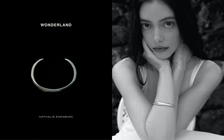 Black and white portrait of a woman resting chin on hands wearing a silver bangle bracelet