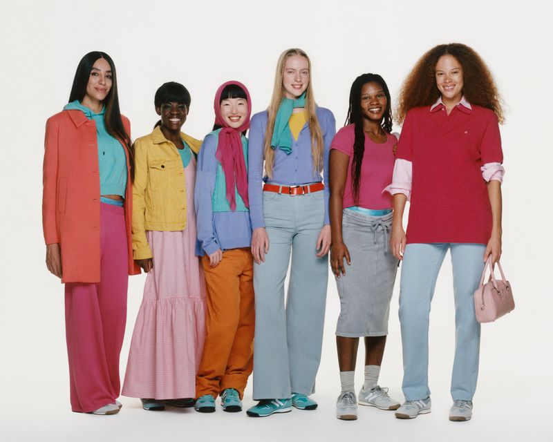 Diverse group of six adult women in casual spring fashion, vibrant pastel colors, standing together in a bright studio, fashion editorial.