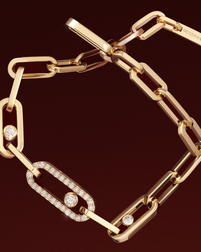 Gold chain bracelet with diamond accents on a dark brown background, jewelry design for fashion and luxury accessory concepts.