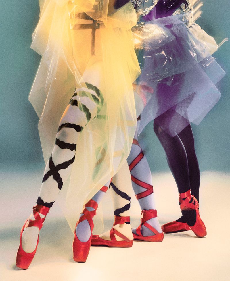 Three ballet dancers in colorful costumes and pointe shoes, captured in a studio setting with a focus on dance fashion and style.