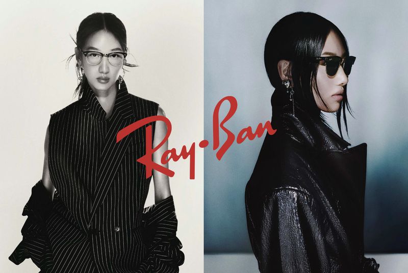 Ray-Ban eyewear ad featuring two Asian women modeling different styles of glasses, with a prominent Ray-Ban logo in the center.