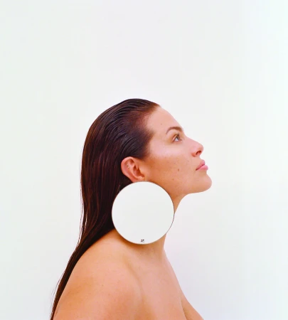 Profile portrait of Ashley Graham wearing large circular earrings against a plain white background for Love Want Issue 31