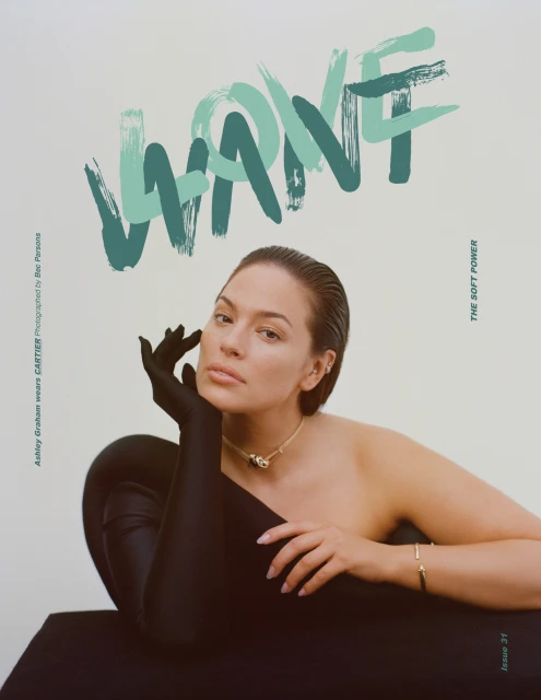 Ashley Graham magazine cover portrait; model poses in black gloves and dress, wearing a gold necklace, with WANT text graphic overlay.