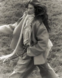 Model with long dark hair walking outdoors wearing an oversized blazer and trousers for Vautrait