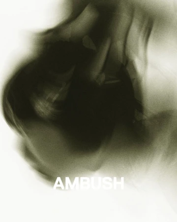Abstract motion blur of green and white creates a smoky effect.  The word AMBUSH is visible in white lettering at the bottom.