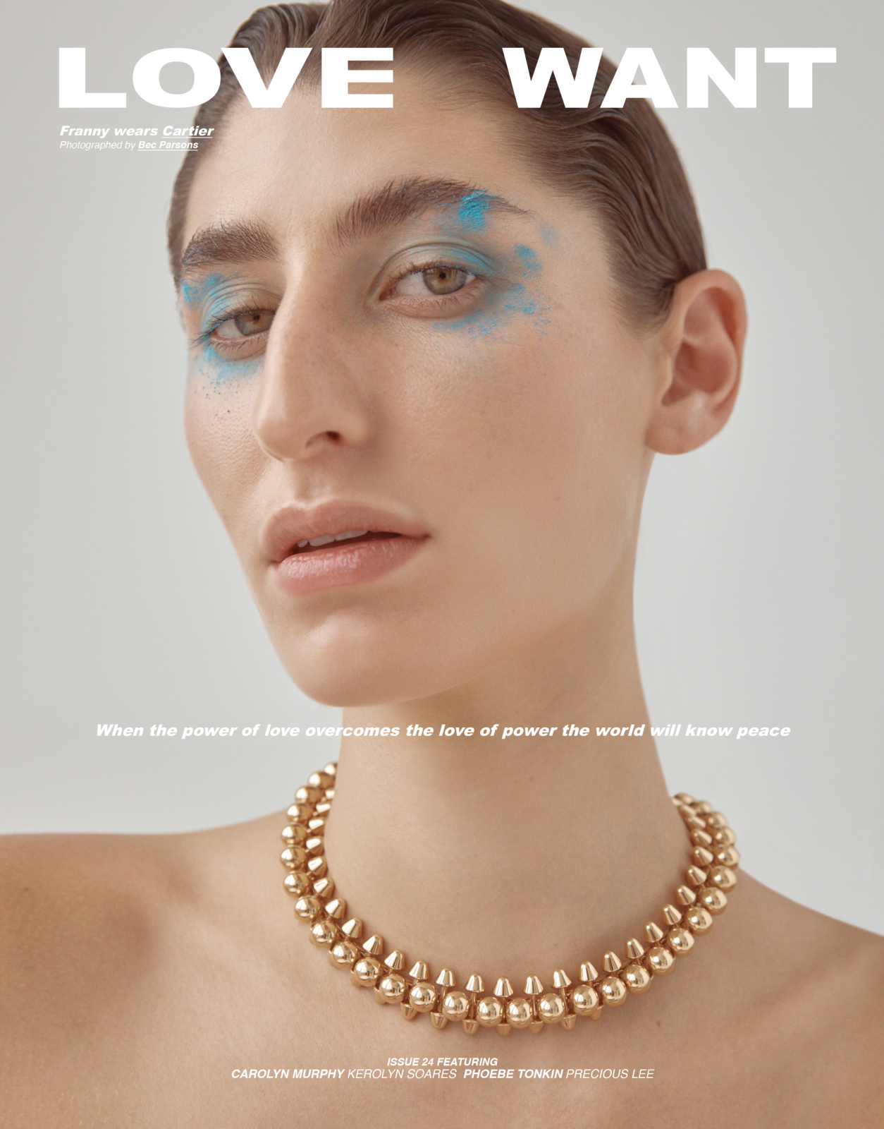 Magazine cover featuring a woman's portrait with blue eye makeup and a gold necklace against a neutral background. Bold sans-serif typography.