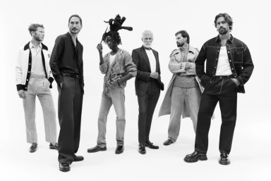 Group of six male models posing in diverse outfits against a plain white background for Mytheresa