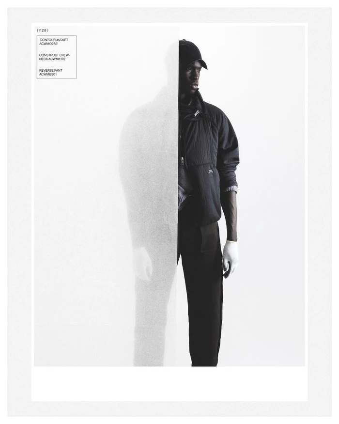 A-Cold-Wall fashion campaign image featuring a black man wearing a dark jacket, baseball cap, and gloves against a white background.