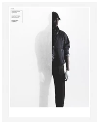 A-Cold-Wall fashion campaign image featuring a black man wearing a dark jacket, baseball cap, and gloves against a white background.